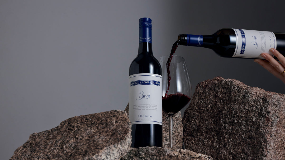 Langi Shiraz being poured into glass on granite rocks