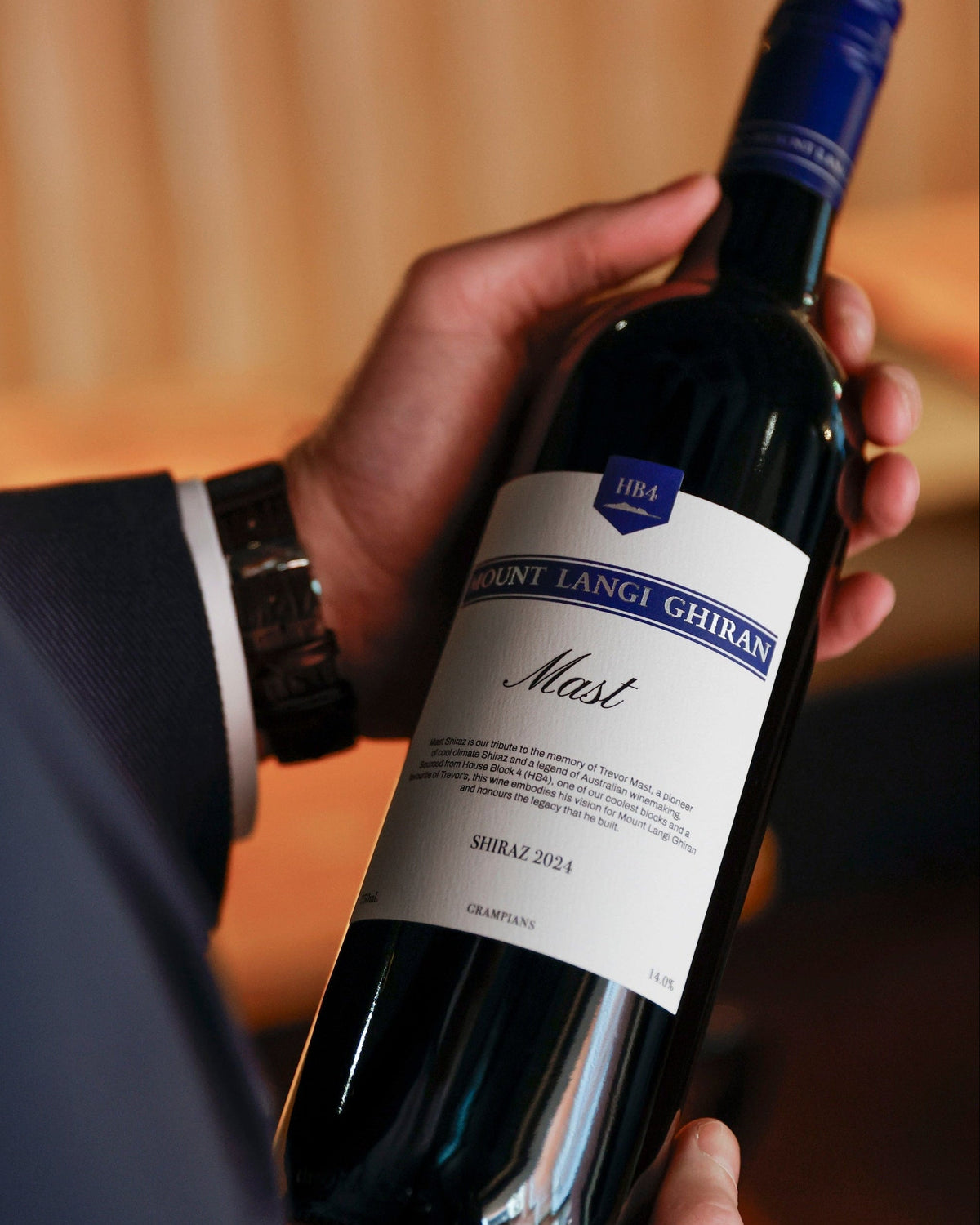 Man reading Mast Shiraz label