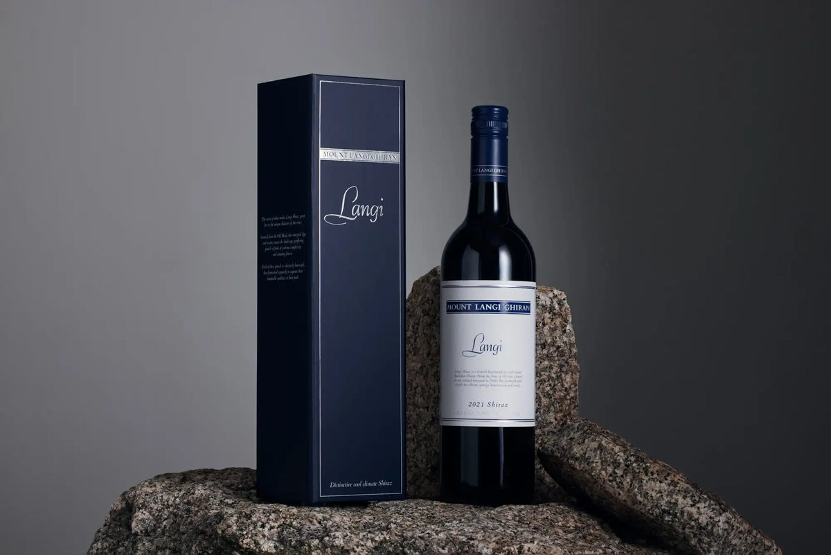 Bottle of Mount Langi Ghiran Langi Shiraz beside its gift box on granite rocks