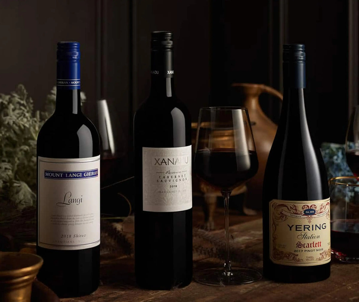 Three wine bottles including Mount Langi Ghiran Langi, Xanadu Cabernet Sauvignon, and Yering Station Scarlett Pinot Noir displayed together